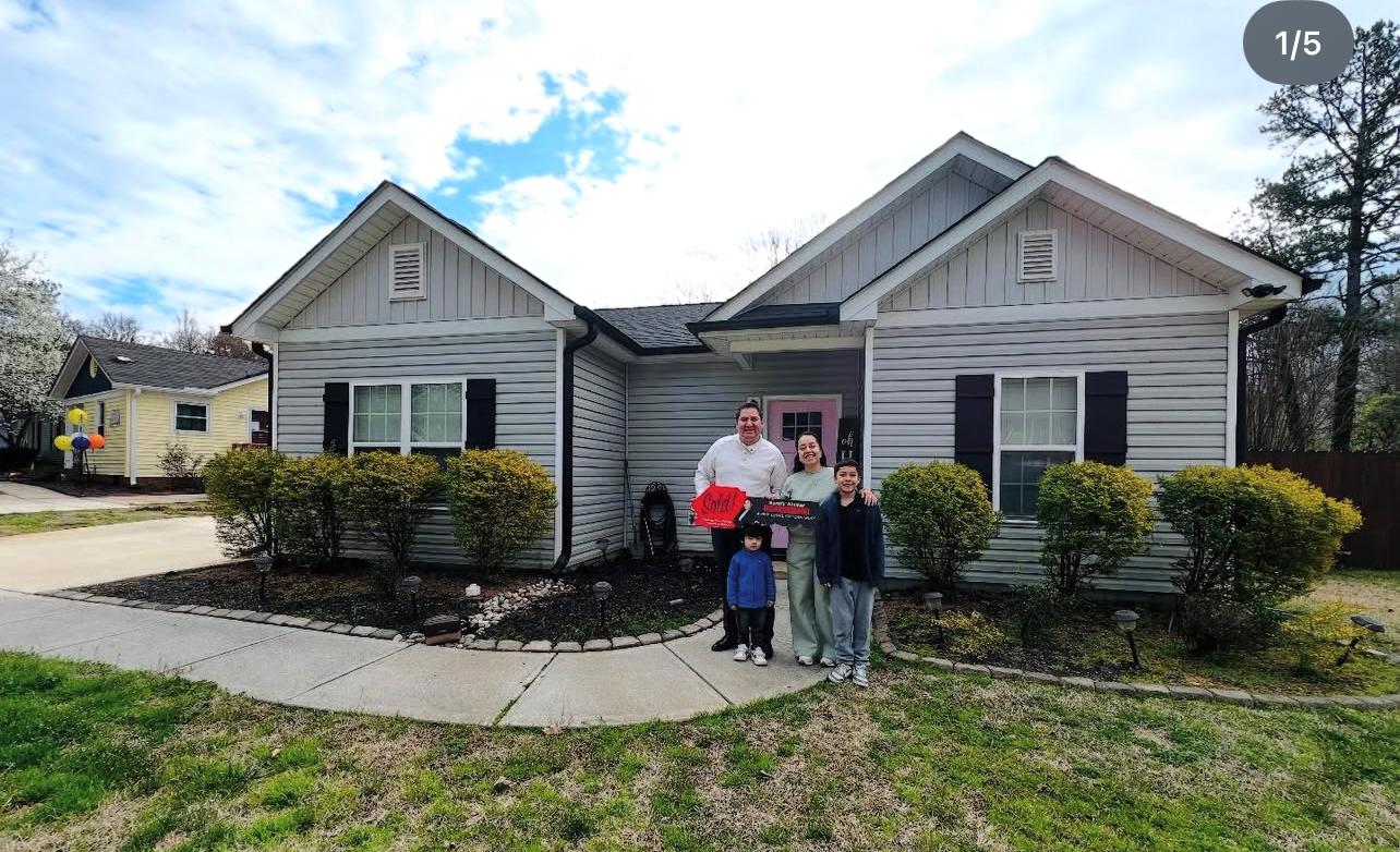 Happy clients with Sandy Alvear at sold home